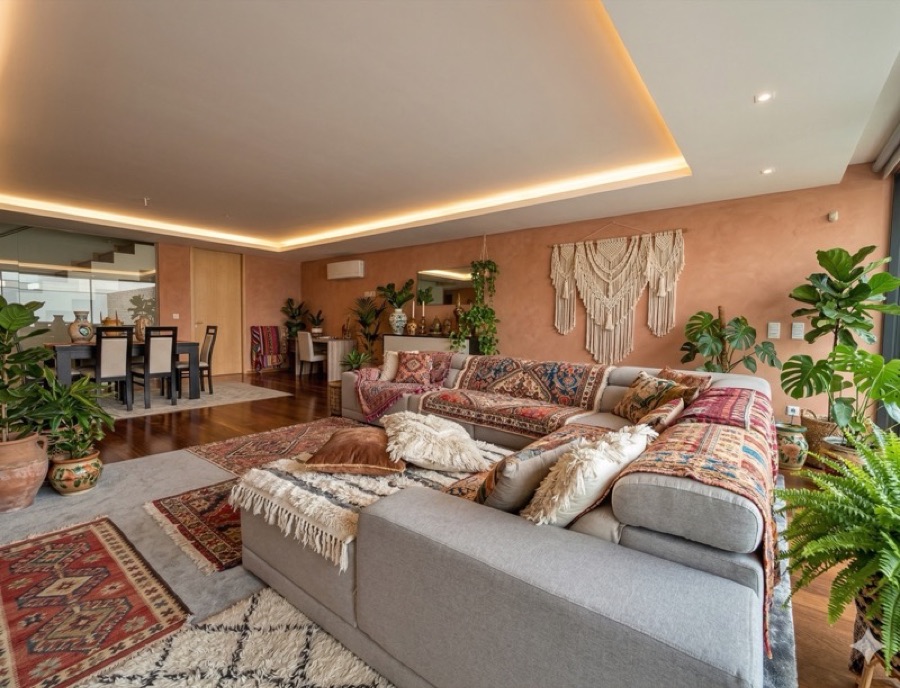A room restyled in Bohemian design — layered textiles and plants.